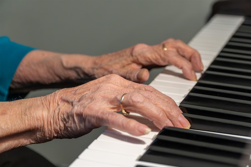 Hands of Elderly Woman Resident of Borden Care Home Playing Piano
